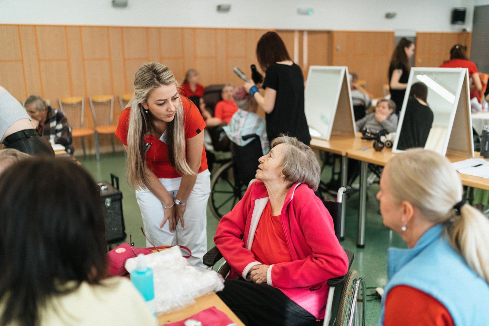 Caregivers helping seniors during an activity session at a senior day center